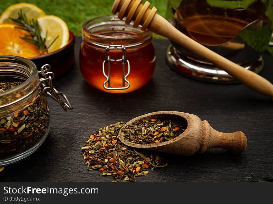 Close up of herbal tea and honey over black background