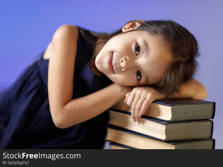 Cute little girl is reading a book.