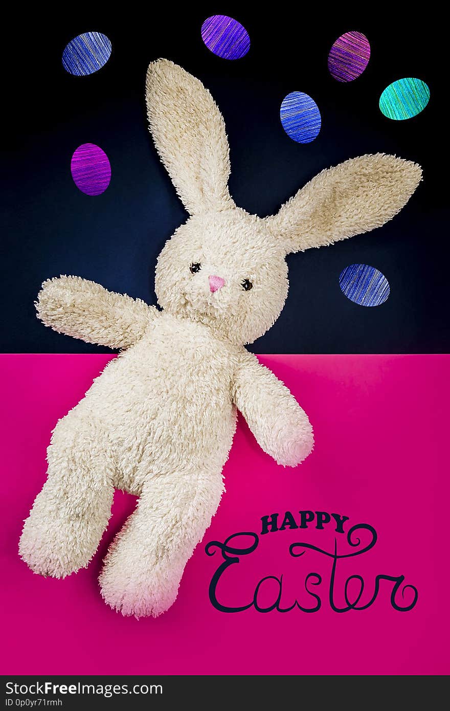 Happy Easter - card. Toy hare on a pink background