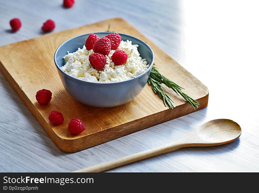 Cottage cheese with fresh raspberries in a bowl, healthy breakfast