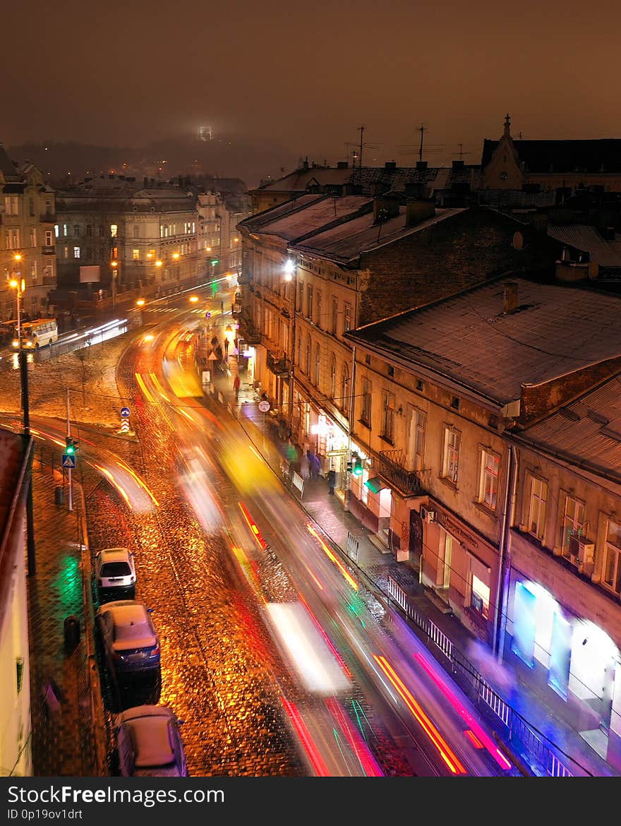 Aerial view of one of the central streets of Lviv in evening. Blurred car lights