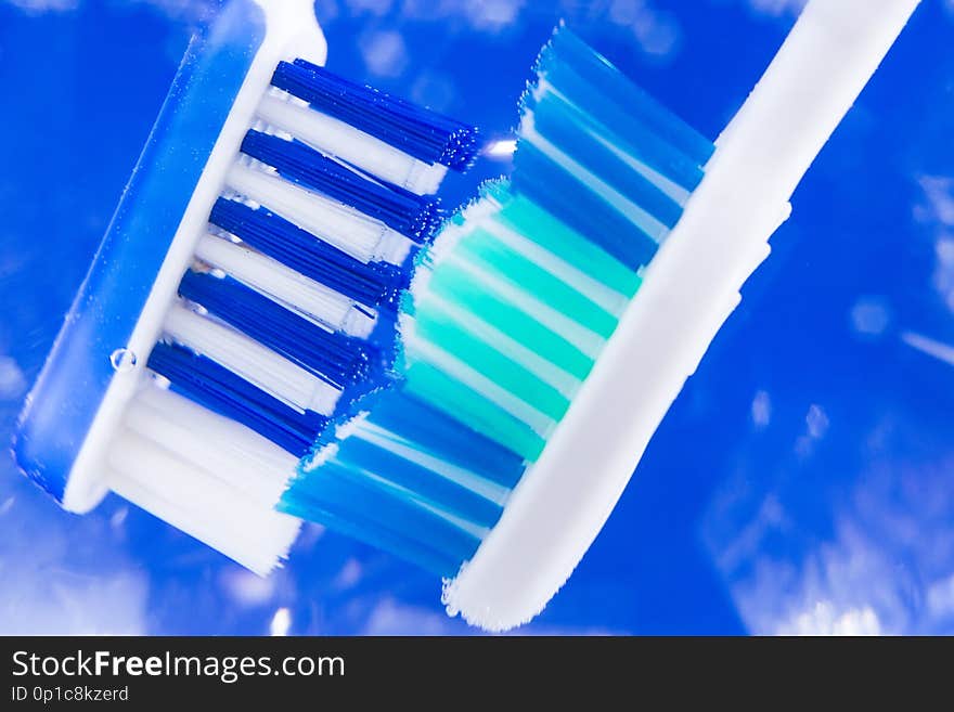 Toothbrush closeup closeup on a blue background the concept of oral hygiene. Toothbrush closeup closeup on a blue background the concept of oral hygiene