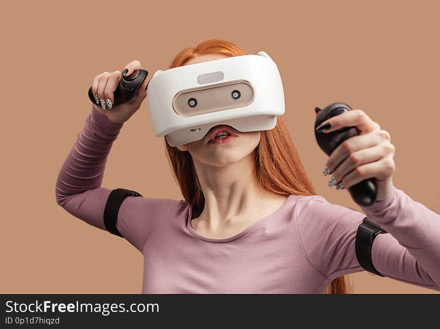 Emotional female with red long hair standing experiencing vertual reality headset for the first time. Generation of realistic images of alternative digital reality. Emotional female with red long hair standing experiencing vertual reality headset for the first time. Generation of realistic images of alternative digital reality