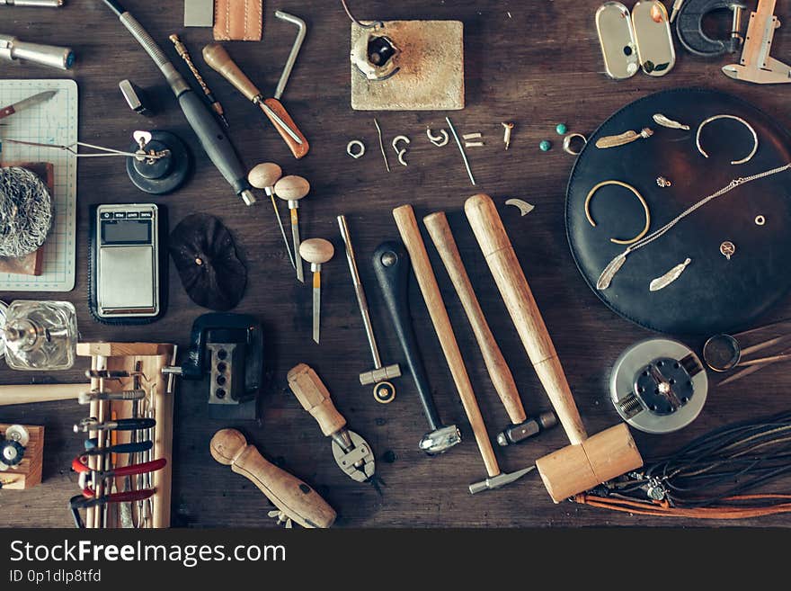 Top view photo. table is full of tools for making, repairing adornmnet