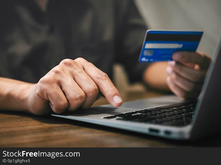 Businessman holding credit card and typing on laptop for online shopping and payment makes a purchase on the Internet, Online payment, Business financial and technology