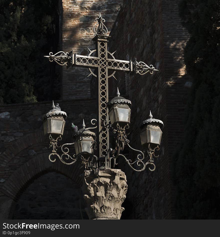 Religious cross on an old lampost.