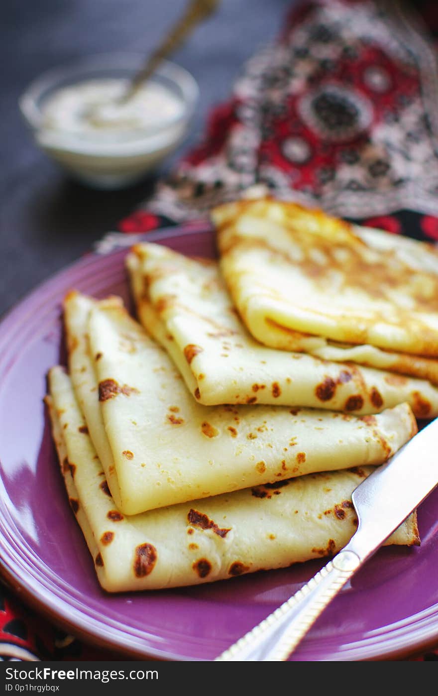 Stack of homemade thin pancakes or crepes or pancake cake, selective focus