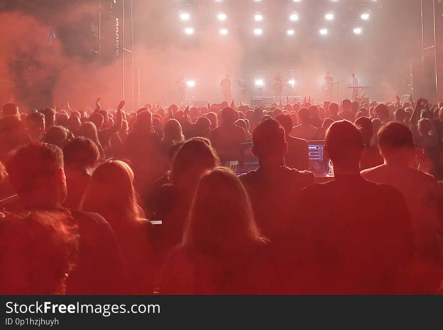 Crowd of people with raised hands on the dance floor in night club. Crowd of people with raised hands on the dance floor in night club