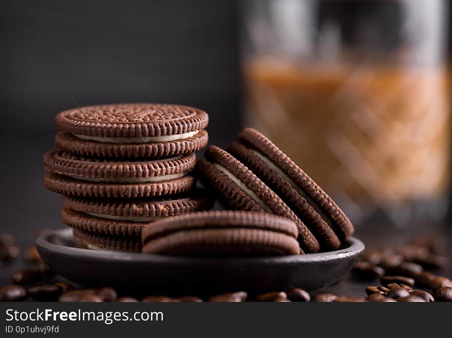 Chocolate chips cookies on black background. Latte coffee on background.