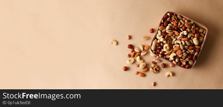 Dried fruits and nuts mix in a wooden bowl.