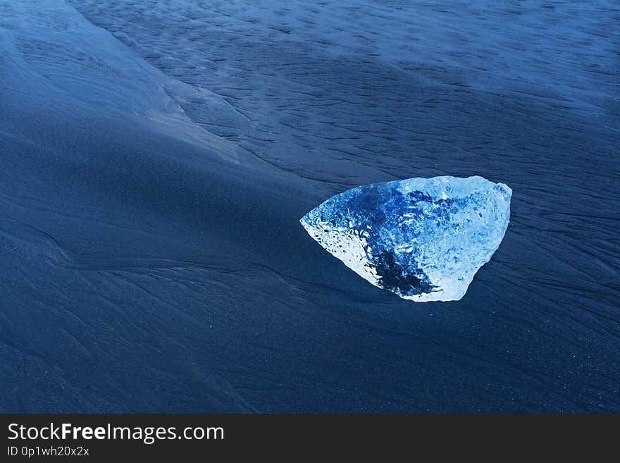 Beautiful sunset over famous Diamond beach, Iceland. This sand lava beach is full of many giant ice gems. Iceland