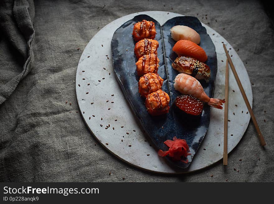 Japanese cuisine on handmade ceramics. Sushi and roll