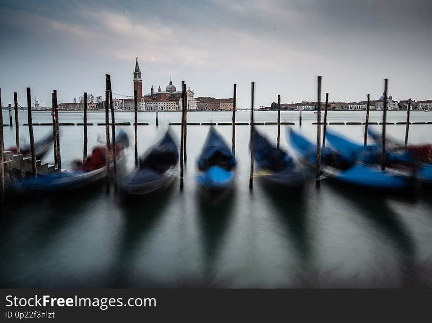 The dancing goldola`s accross from church of San Giorgio Maggiore at sunset. The dancing goldola`s accross from church of San Giorgio Maggiore at sunset