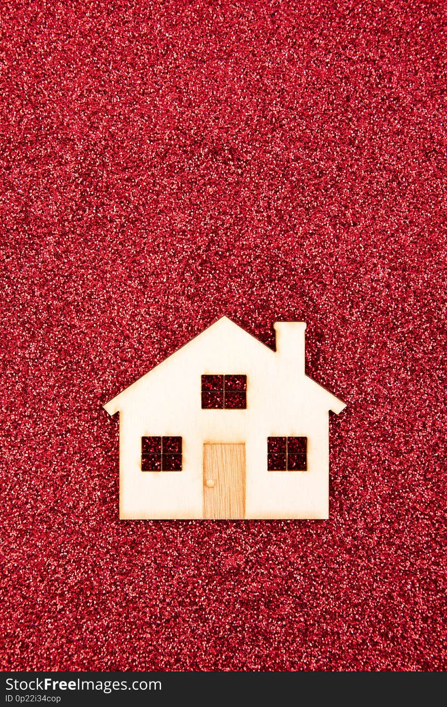 Small house shape on red glitter background