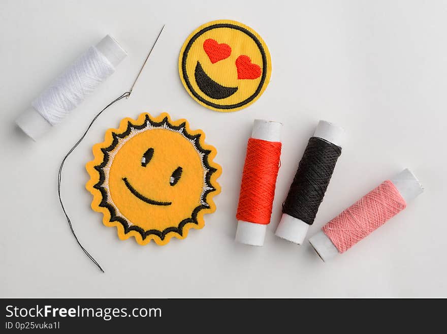 Emoji embroidered patches and thread