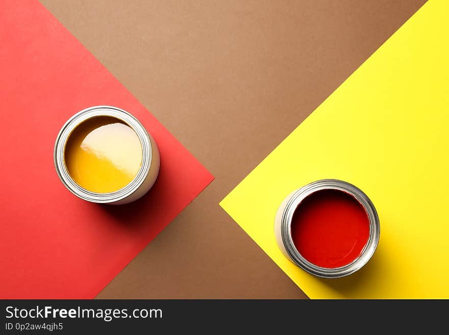 Flat lay composition with paint cans and space for text on color background