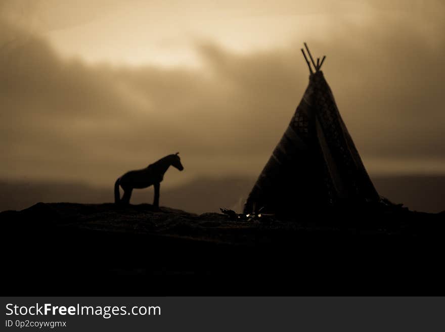 Artwork decoration creative concept. An old native american teepee in desert at the evening. Wigwam house indian style. Artwork decoration creative concept. An old native american teepee in desert at the evening. Wigwam house indian style