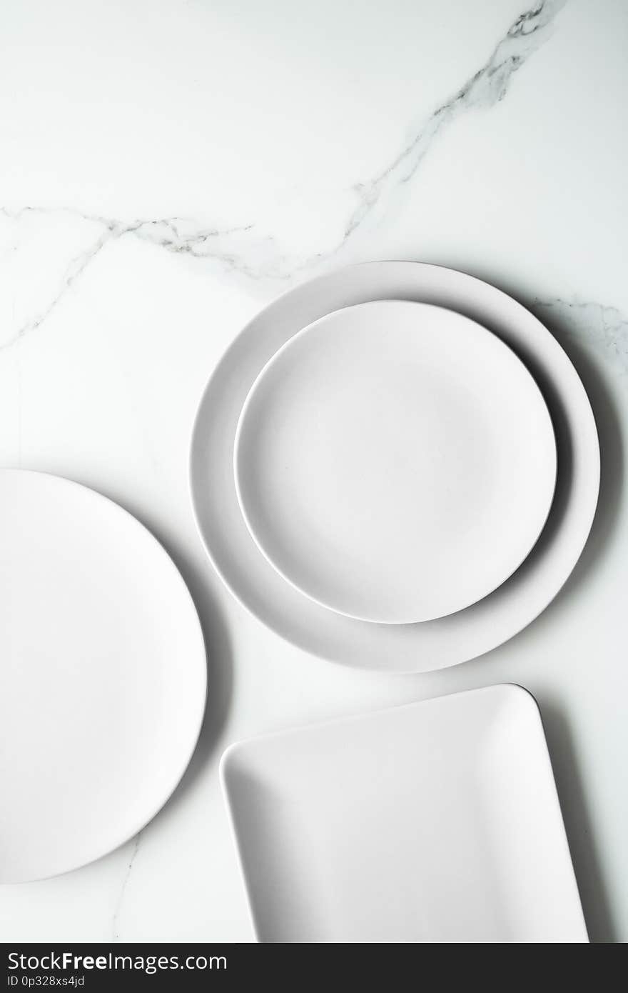 White empty plate on marble, flatlay - stylish tableware, romantic table decor and food menu concept. Serve the perfect dish. White empty plate on marble, flatlay - stylish tableware, romantic table decor and food menu concept. Serve the perfect dish