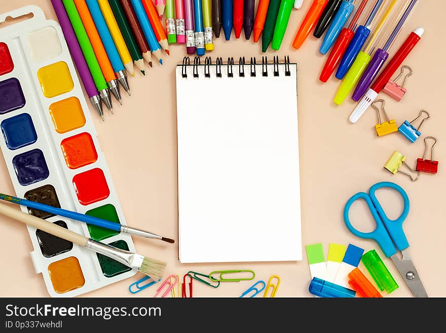 School and office supplies with empty notepad on table. Top view with copy space.