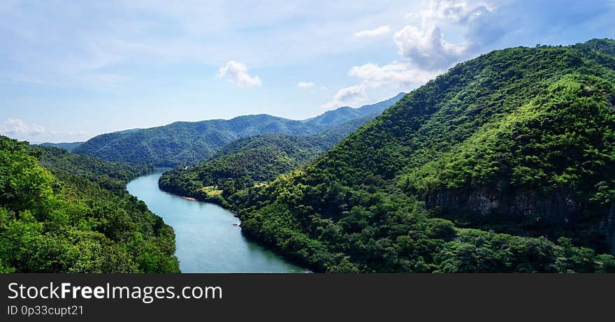 Beautiful panorama: Top view blue river in green mountains valley. Travel, tourism, wanderlust concept. Text space