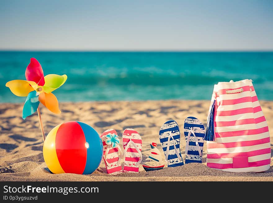 Beach flip-flops on the sand. Summer vacation concept. Beach flip-flops on the sand. Summer vacation concept