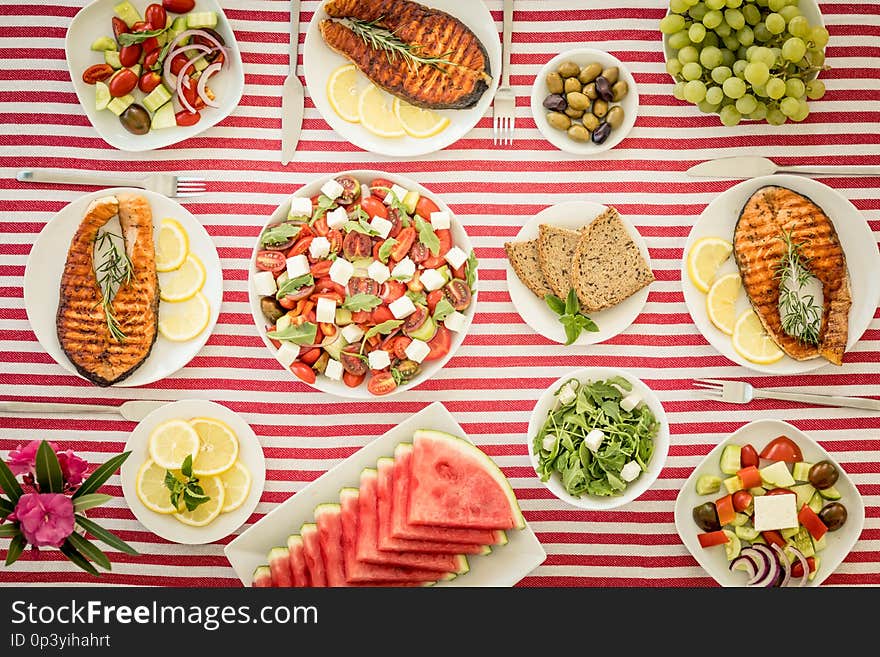 Top view of table with fish, salads, fruits and vegetables. Mediterranean diet. Healthy food concept. Top view of table with fish, salads, fruits and vegetables. Mediterranean diet. Healthy food concept