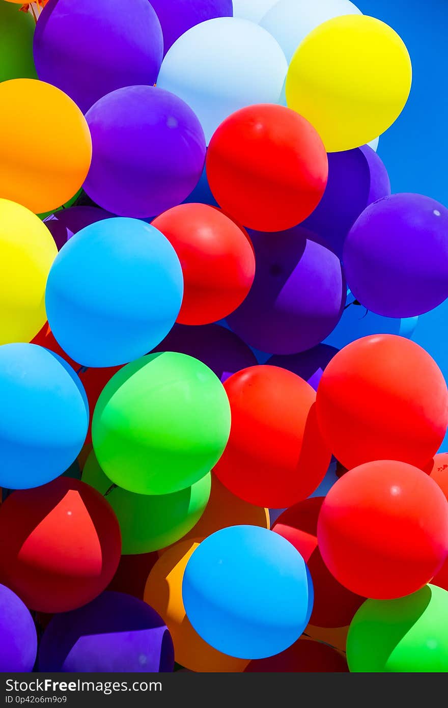 Background of a set of colored balloons on the sky background