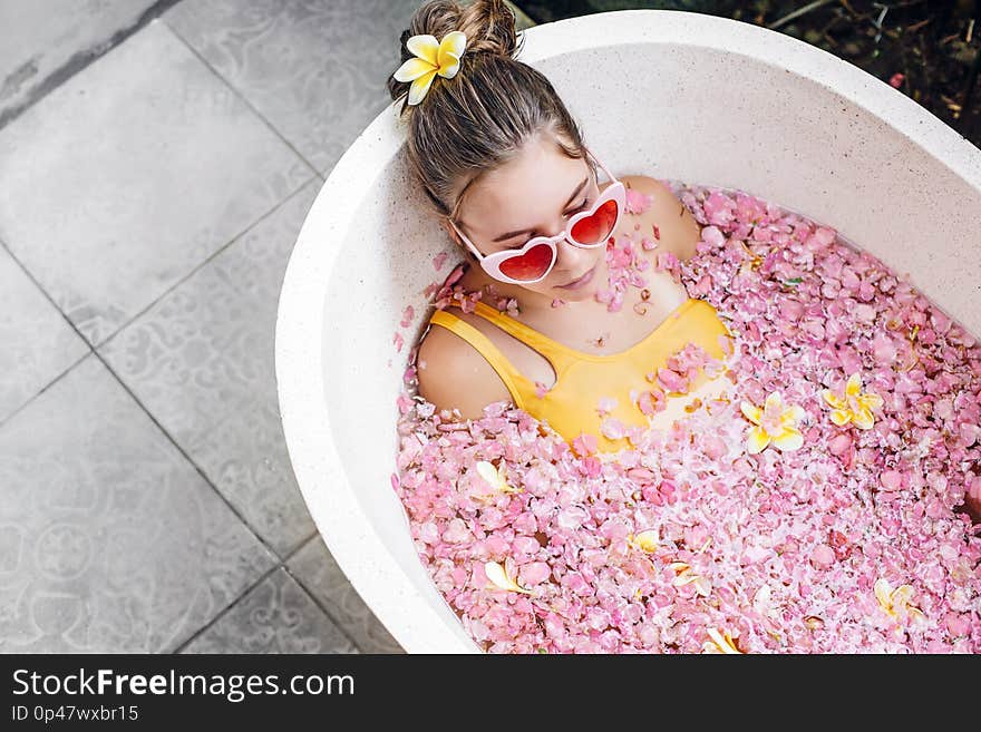 Girl Relaxing In Spa Bath With Flowers