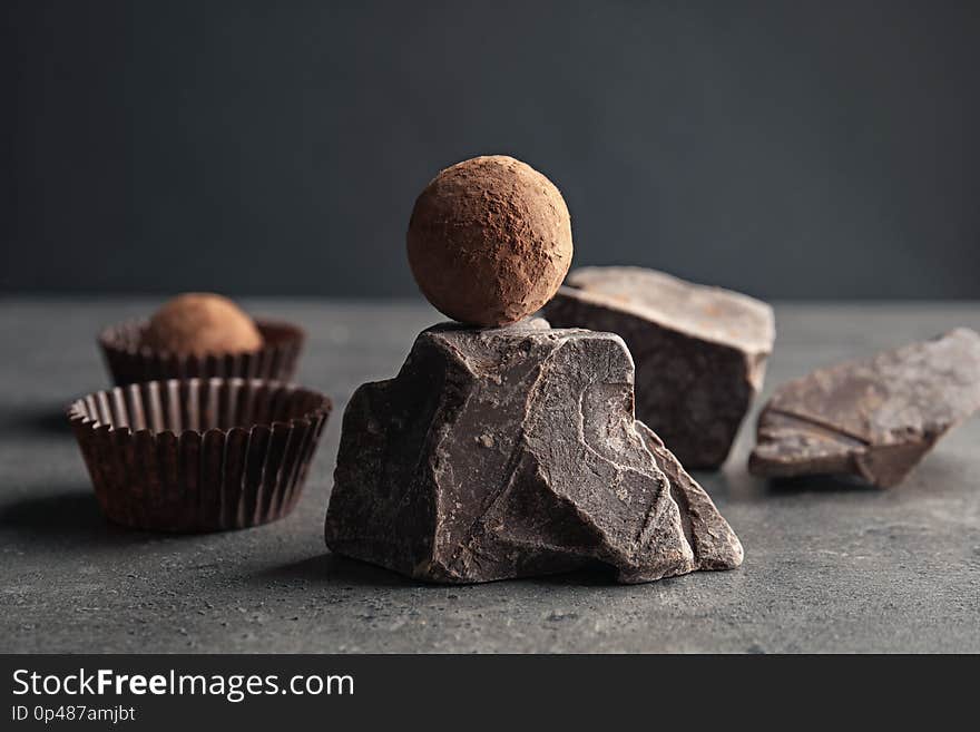 Tasty raw truffle and chocolate lump on grey table