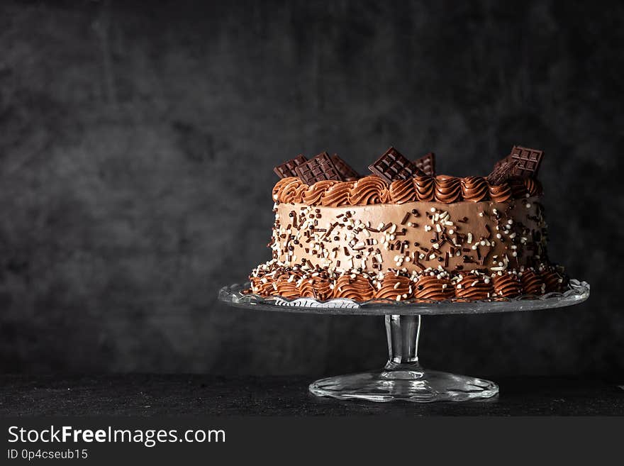 Decorated chocolate cake on dark background