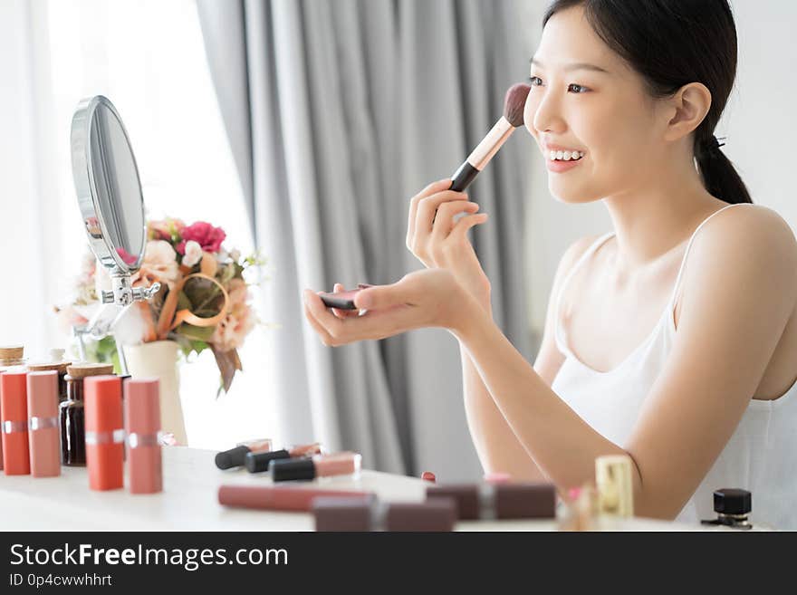 Young Asian female makeup beauty by Makeup Brush.