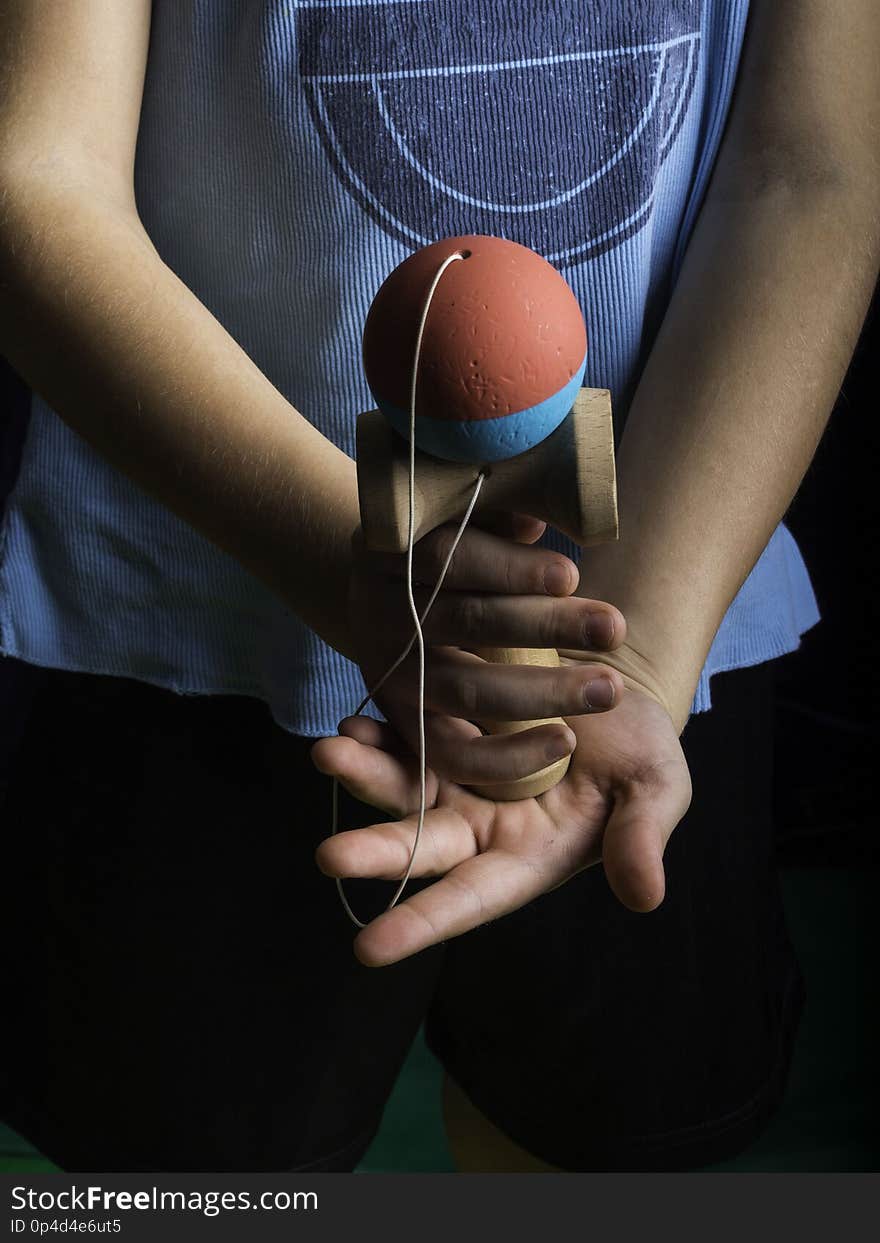 Classic Japanese game kendama, boy hands playing blue and pink color kendama. Classic Japanese game kendama, boy hands playing blue and pink color kendama