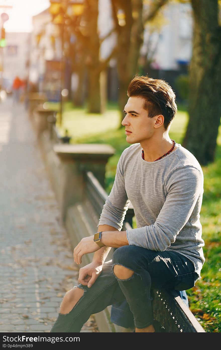 Stylish man walking through the city by himself. Stylish man walking through the city by himself