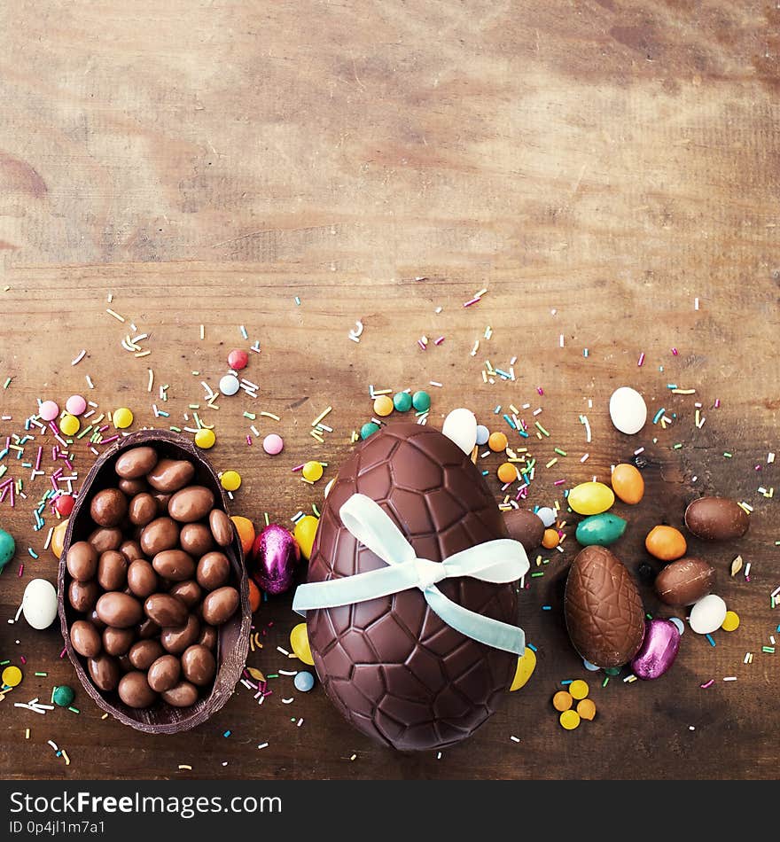 Beautiful creative photo with Chocolate Easter eggs on wooden background. Happy Easter