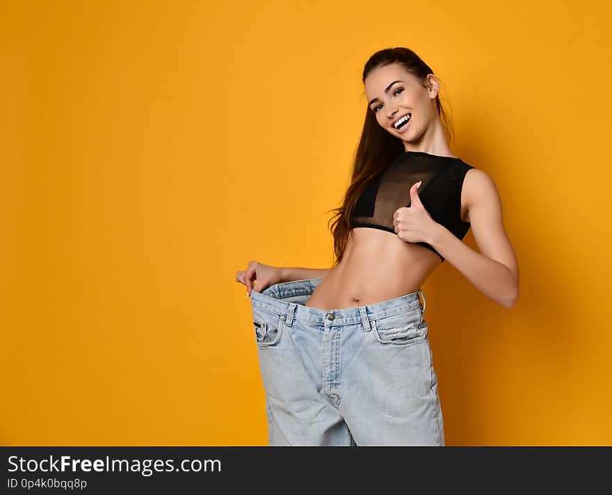 Beautiful young woman with big jeans