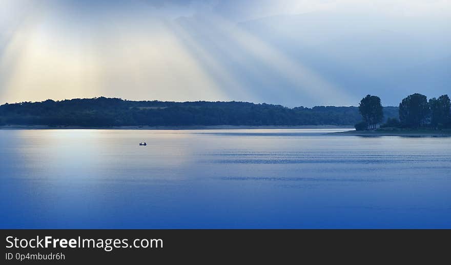 Beautiful Blue Nature Background.Fantasy Design.Artistic Wallpaper.Art Photography.Sky,clouds,water.Lake,trees.Mountain,boat.Light