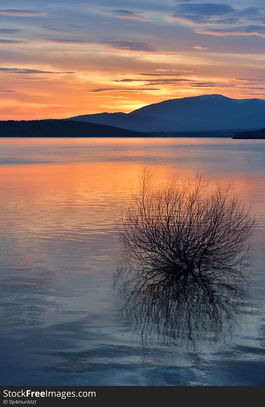 Beautiful Orange Nature Background.Sunset,sunrise.Artistic Wallpaper.Art Photography.Sky,clouds,water.Lake,trees.Mountain.Light.