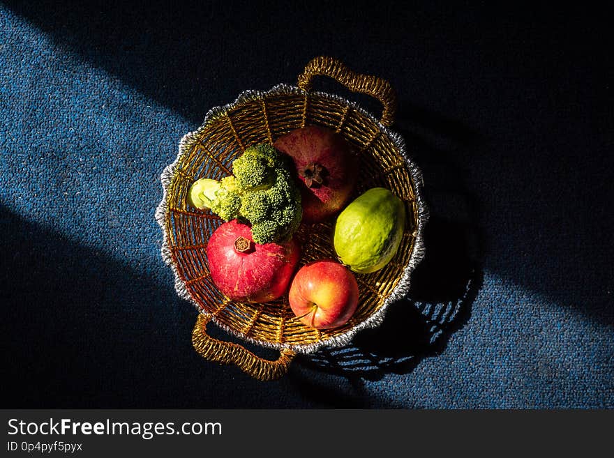 Creative Moody Shot Of Fruit And Vegitable In A Golden Basket