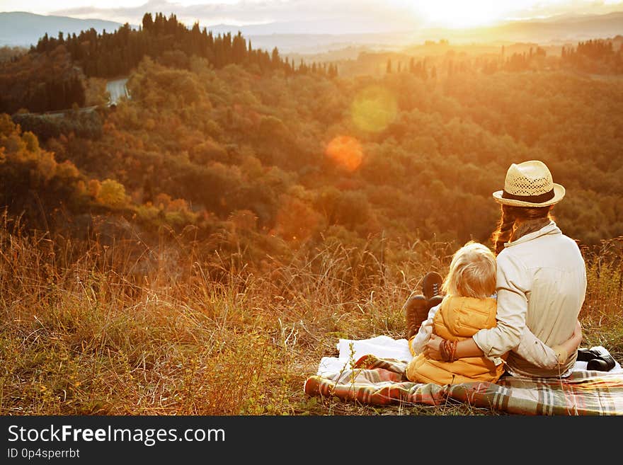 Mother and child hikers looking into the distance while sitting