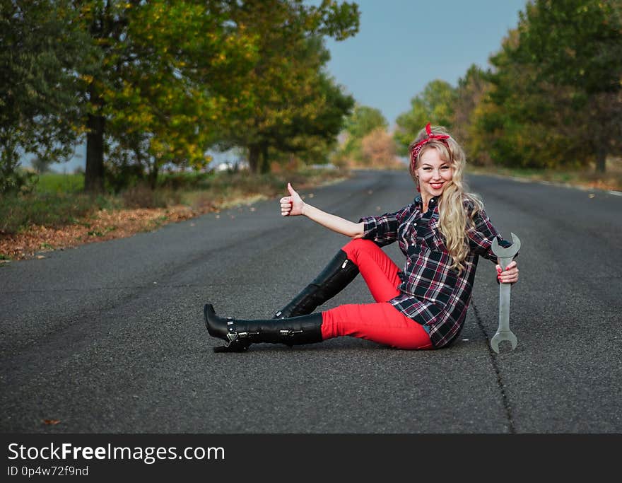 Beautiful blond girl with a spanner. Beautiful blond girl with a spanner.