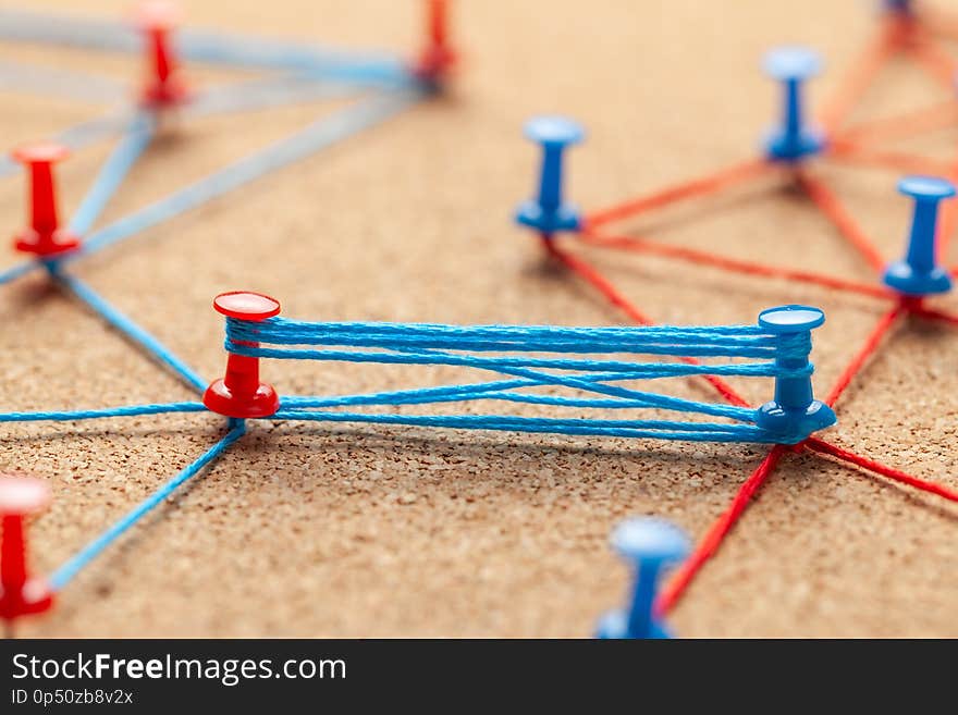 Business team. Connect between business partners people. Contract and negotiation. Blue and red knitted office pins and strong