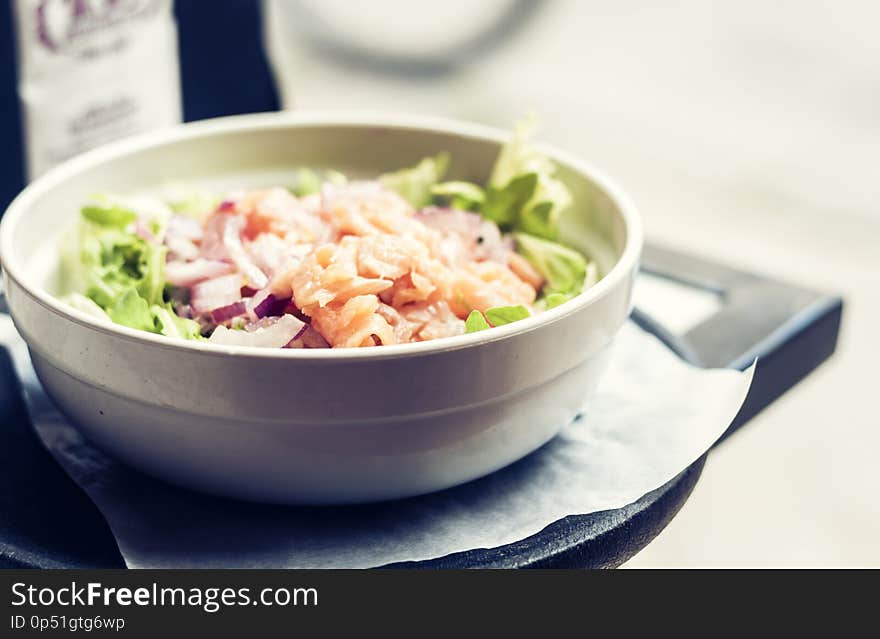 Smoked salmon salad with red onion in restaurant in Syracuse, Sicily, Italy