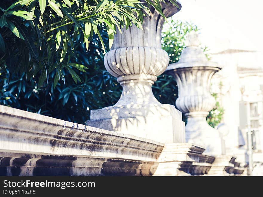 Old baroque fence with stone plant pots in Catania, Sicily, Italy