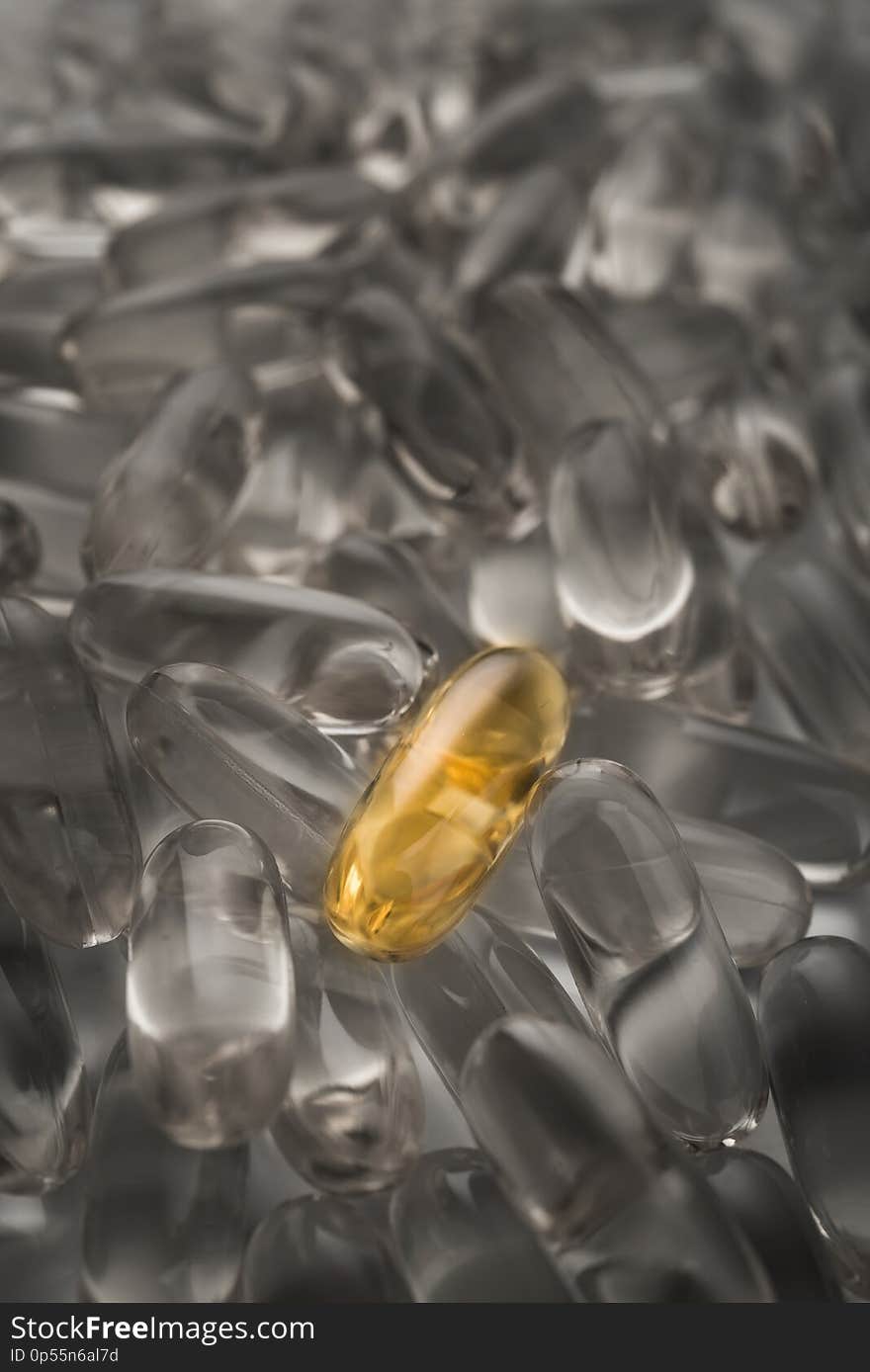 One golden pill not like everyone. Omega 3 capsule background