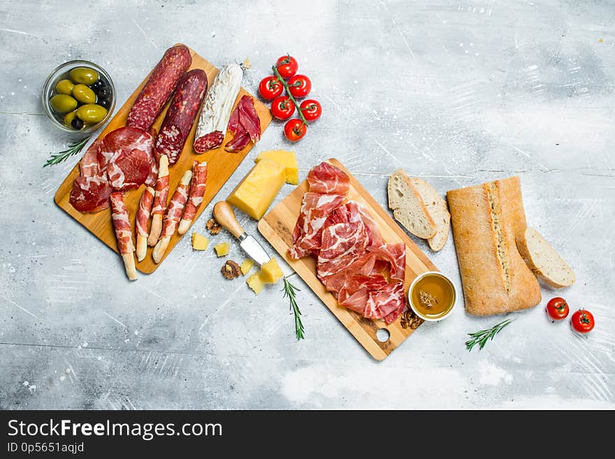 Antipasto background. Variety of Italian snacks. On a rustic background