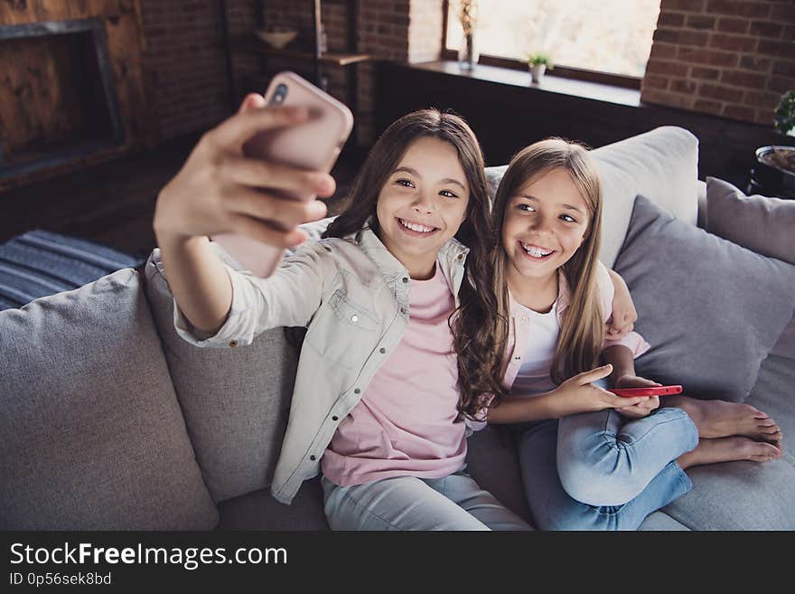 Above high angle view of two nice lovely attractive charming cheerful cheery glad optimistic girls sitting on divan