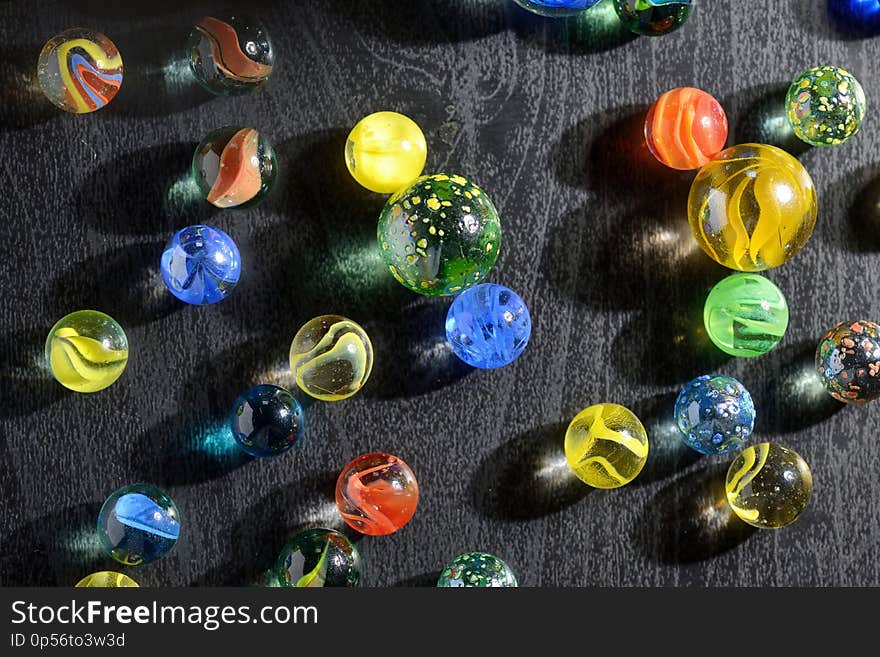 Glass marble balls and shadows on table