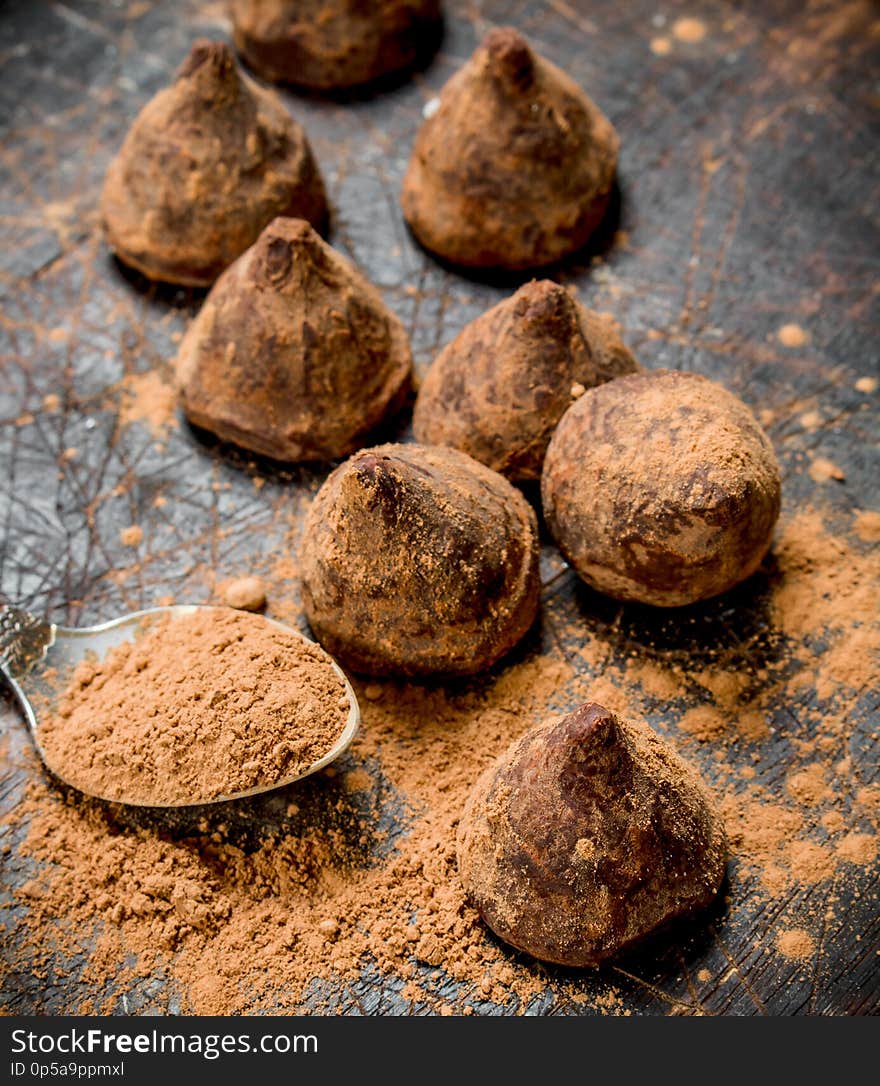 Chocolate candy truffles. On a wooden background