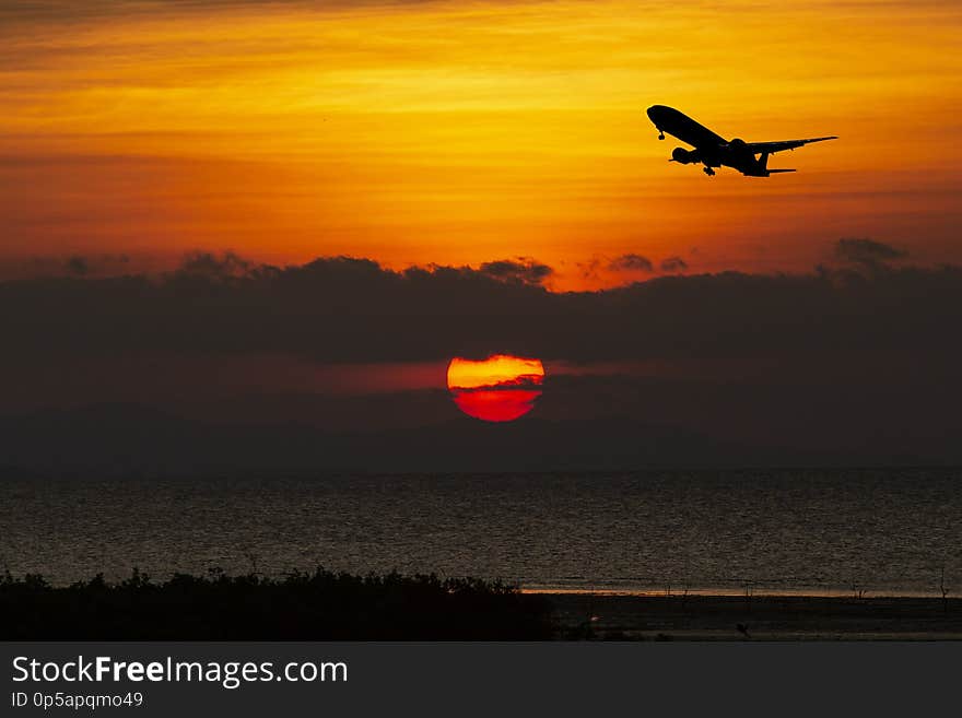 Airplane taking off airport sky-diving industry cargo business, concept: passenger Commercial modern navigable Travel and business,Silhouette aircraft is flying above skyline sun. Airplane taking off airport sky-diving industry cargo business, concept: passenger Commercial modern navigable Travel and business,Silhouette aircraft is flying above skyline sun