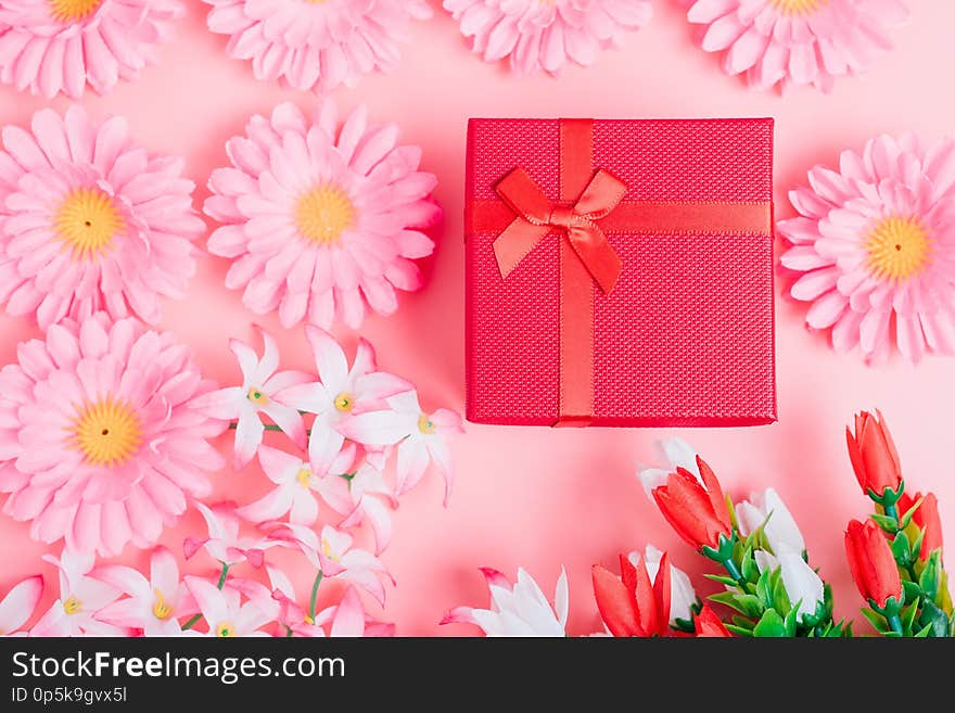 Fower and gift box on pink background with copy space, valentine day concept. Fower and gift box on pink background with copy space, valentine day concept